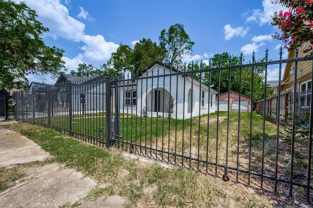 view of gate with a lawn