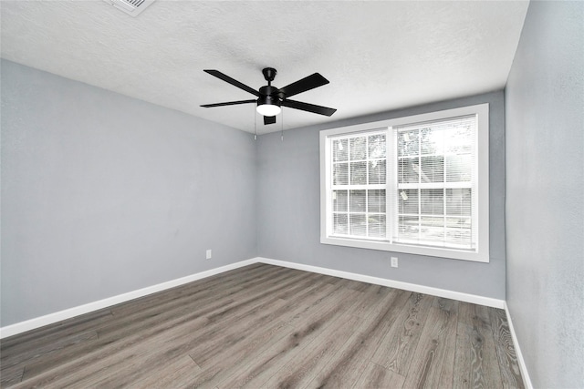 unfurnished room with hardwood / wood-style floors, a textured ceiling, and ceiling fan