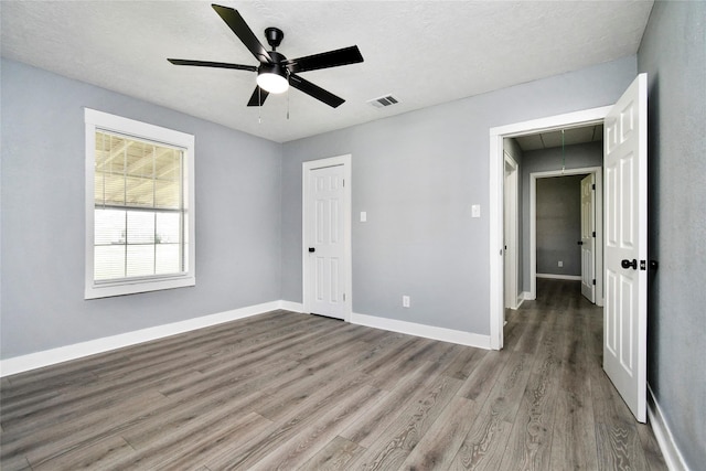 unfurnished bedroom featuring wood-type flooring and ceiling fan