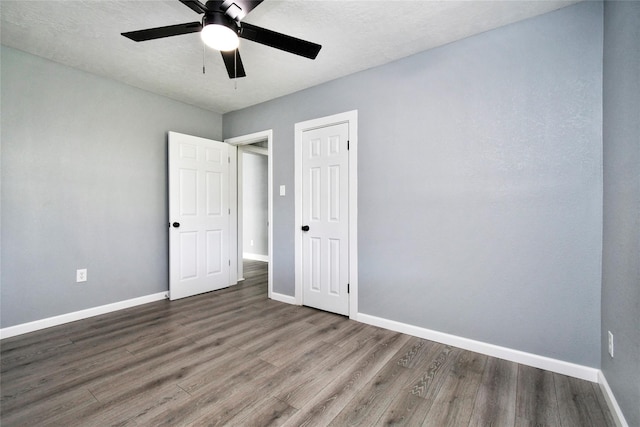 unfurnished bedroom with wood-type flooring and ceiling fan