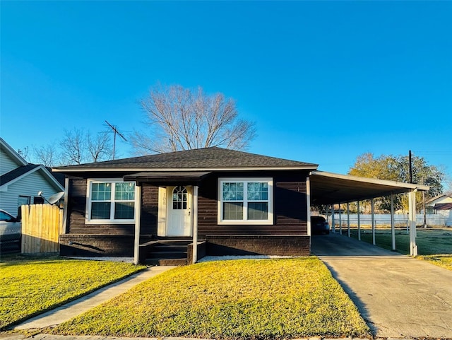 view of front facade with a front lawn and a carport