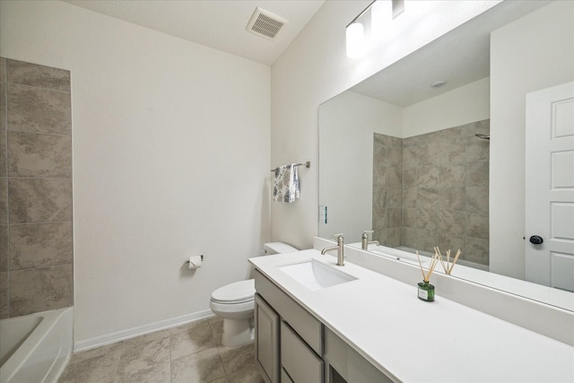 full bathroom with toilet, vanity, and tiled shower / bath