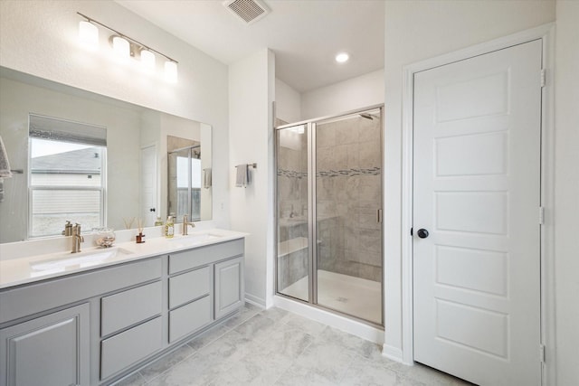 bathroom featuring an enclosed shower and vanity