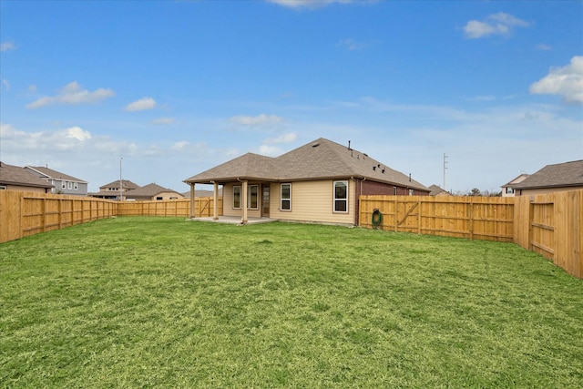 rear view of property featuring a lawn and a patio area