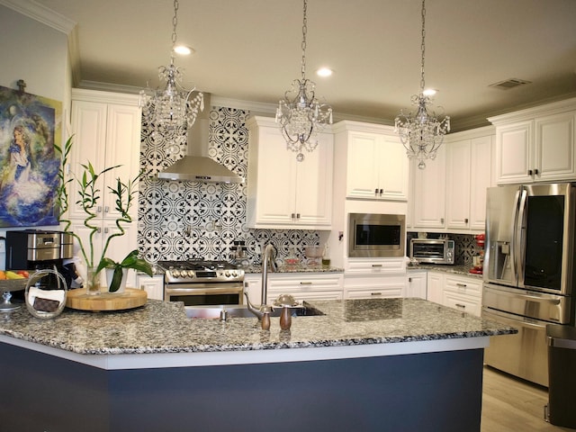 kitchen featuring white cabinetry, stainless steel appliances, decorative light fixtures, and sink