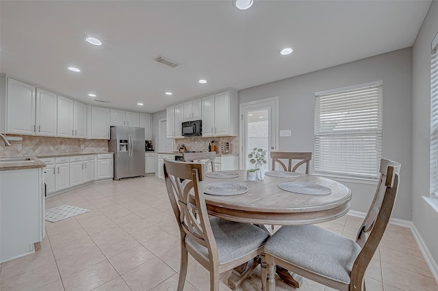 tiled dining area featuring sink