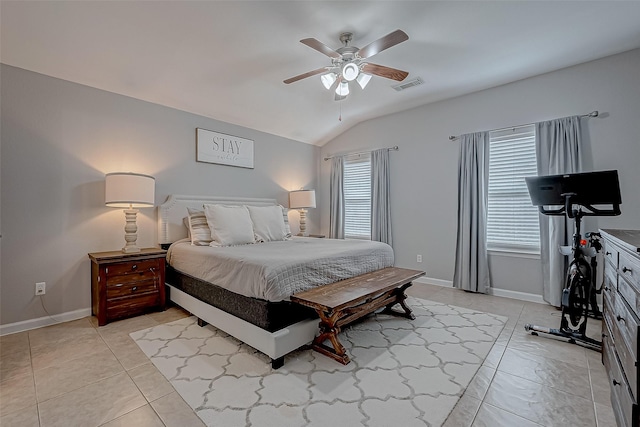 tiled bedroom featuring lofted ceiling and ceiling fan