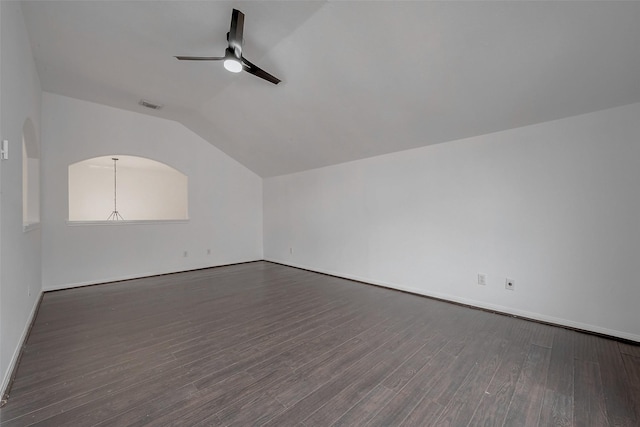 interior space featuring vaulted ceiling, dark wood-type flooring, and ceiling fan