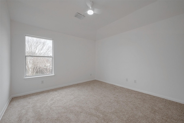 spare room featuring ceiling fan and carpet