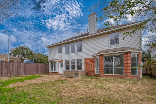 back of property with a lawn