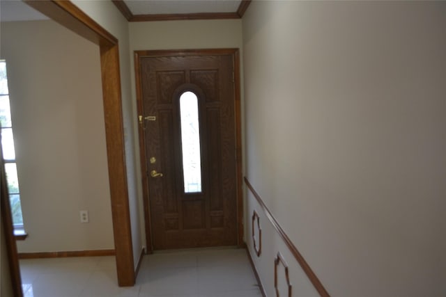 tiled entrance foyer with ornamental molding