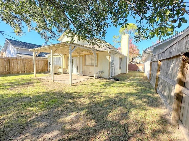 back of house with a lawn and a pergola