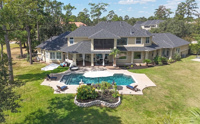 back of house featuring a lawn and a patio