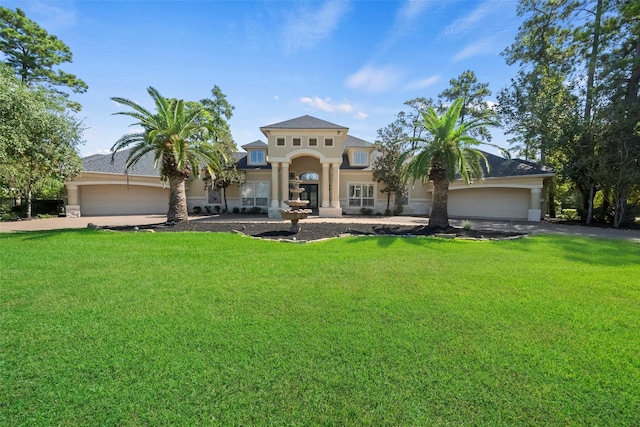 mediterranean / spanish house with a front yard and a garage