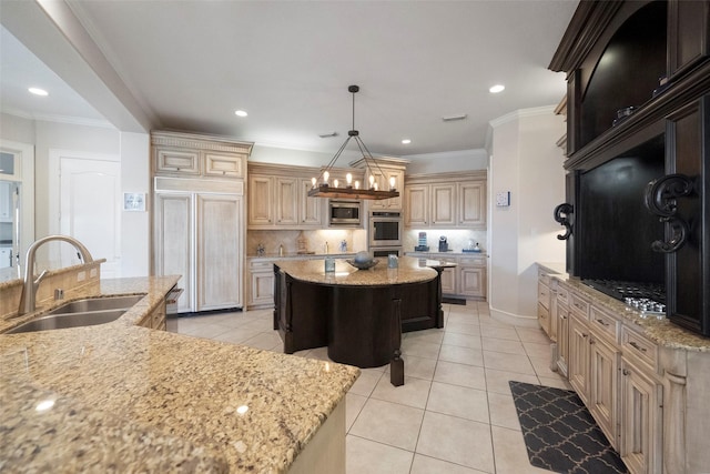 kitchen featuring light stone countertops, sink, light tile patterned floors, and a center island