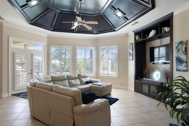 living room with light tile patterned flooring, ceiling fan, ornamental molding, and coffered ceiling