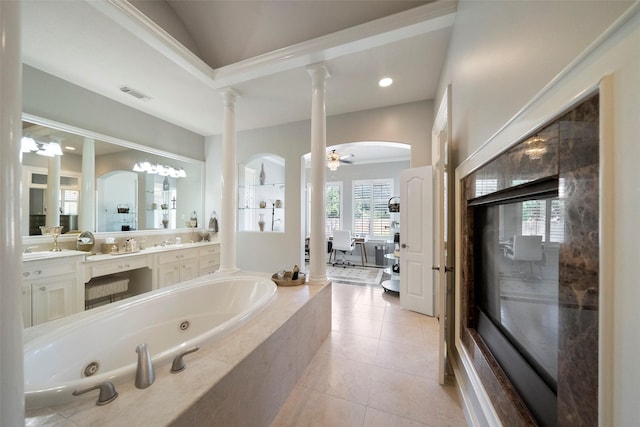 bathroom featuring tile patterned floors, vanity, ceiling fan, tiled bath, and decorative columns