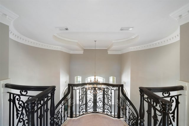 stairs with carpet flooring, crown molding, and an inviting chandelier