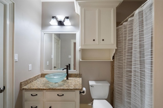 bathroom with toilet and vanity