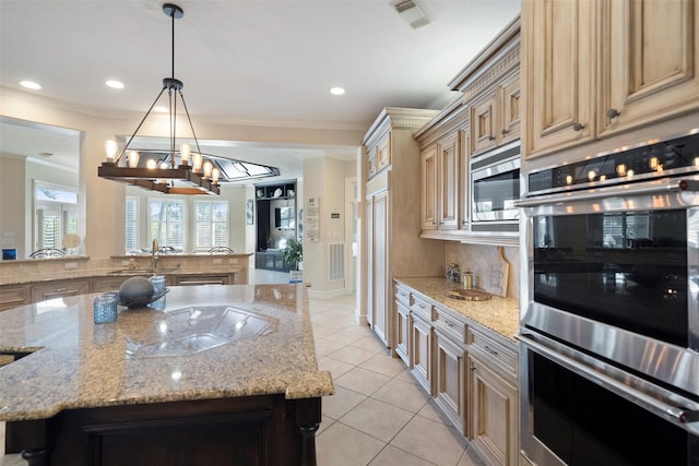 kitchen with decorative light fixtures, a center island, tasteful backsplash, and built in appliances