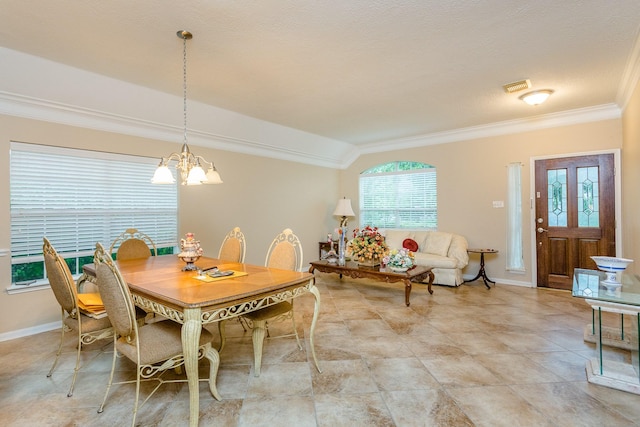 dining space featuring vaulted ceiling, crown molding, and an inviting chandelier