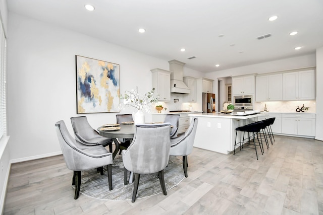 dining room with light hardwood / wood-style floors