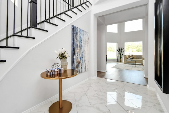 entryway featuring a towering ceiling