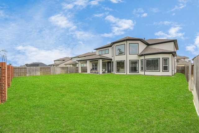 rear view of property with a lawn