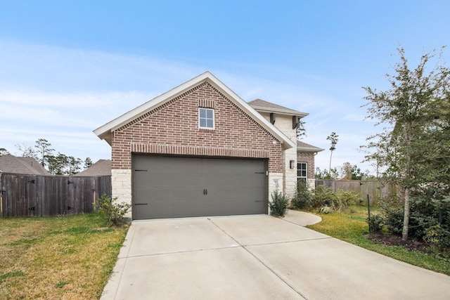 view of front of house featuring a front lawn and a garage