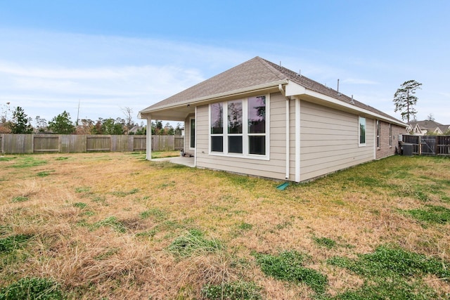 view of side of home with a patio area and a lawn