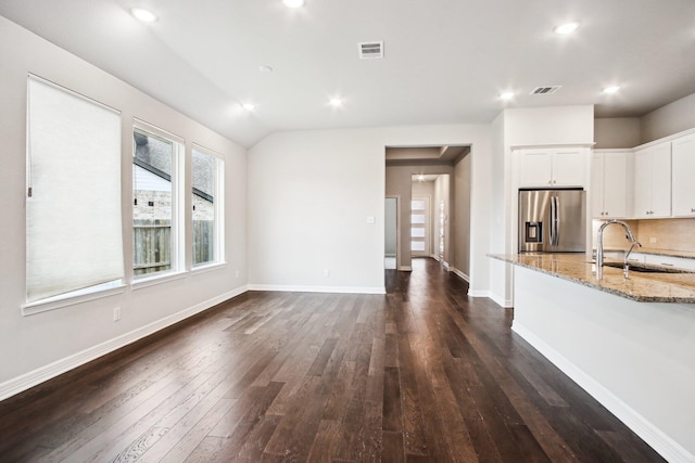 kitchen with sink, light stone countertops, stainless steel fridge with ice dispenser, white cabinets, and dark hardwood / wood-style flooring