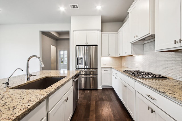 kitchen featuring appliances with stainless steel finishes, sink, and white cabinetry