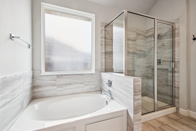 bathroom featuring shower with separate bathtub