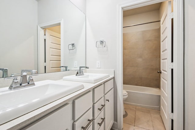 full bathroom with toilet, tile patterned flooring, tiled shower / bath, and vanity