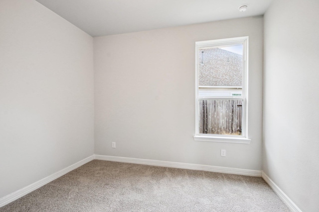 carpeted empty room featuring plenty of natural light