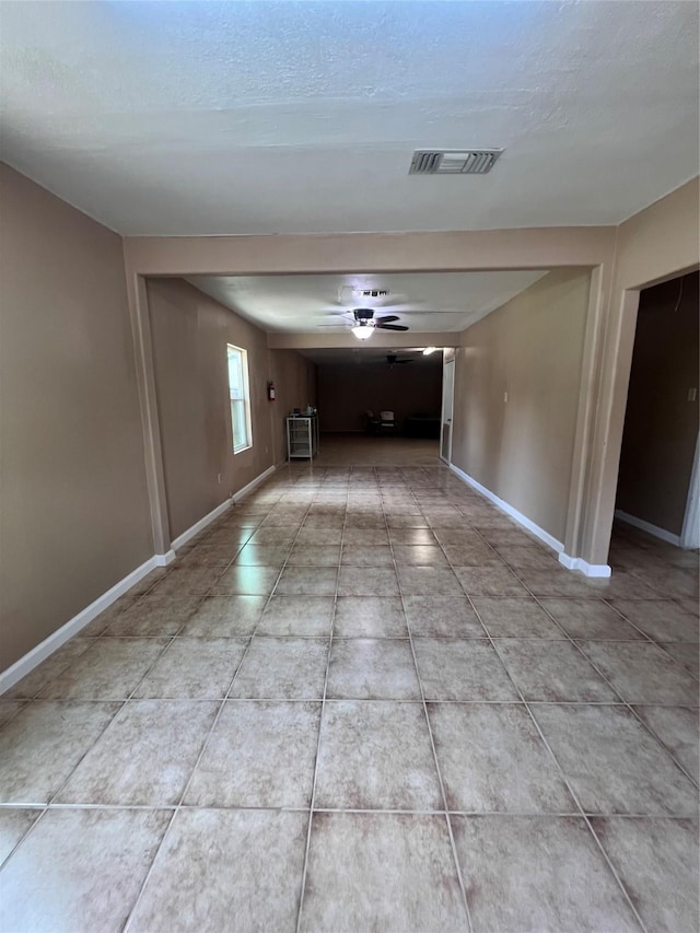 spare room with a textured ceiling and ceiling fan