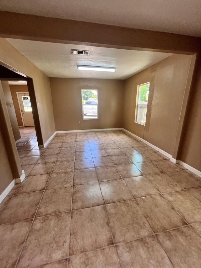 empty room with light tile patterned floors