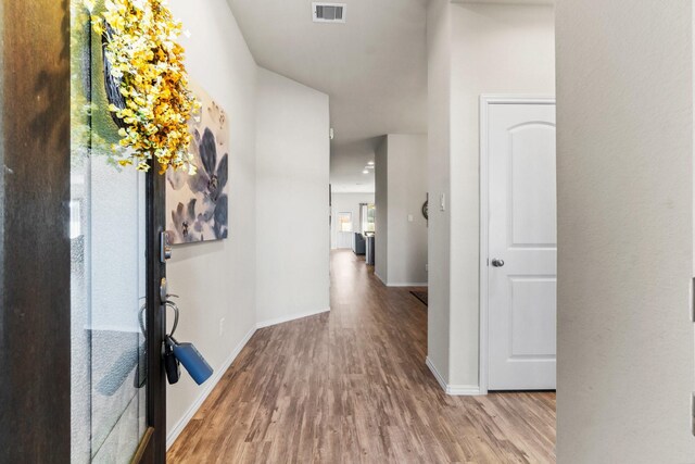 hall with light hardwood / wood-style flooring