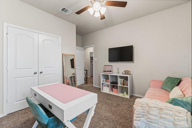 office space featuring ceiling fan and dark colored carpet