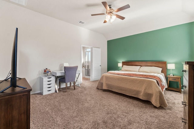 bedroom with ceiling fan, connected bathroom, vaulted ceiling, and carpet