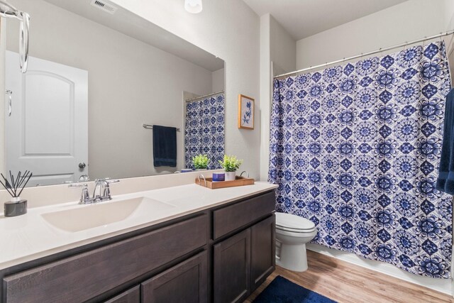 bathroom with vanity, hardwood / wood-style floors, and toilet