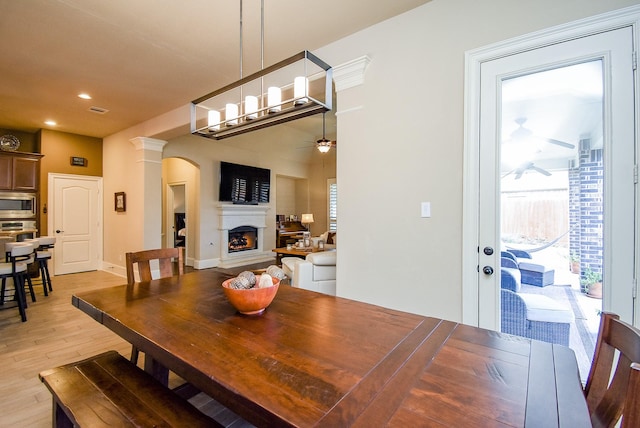 dining area featuring ceiling fan and light wood-type flooring