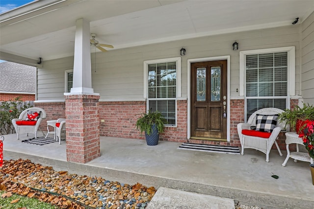 view of exterior entry featuring ceiling fan and a porch