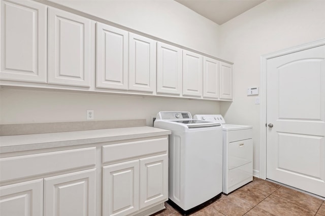 washroom featuring cabinets, separate washer and dryer, and light tile patterned floors