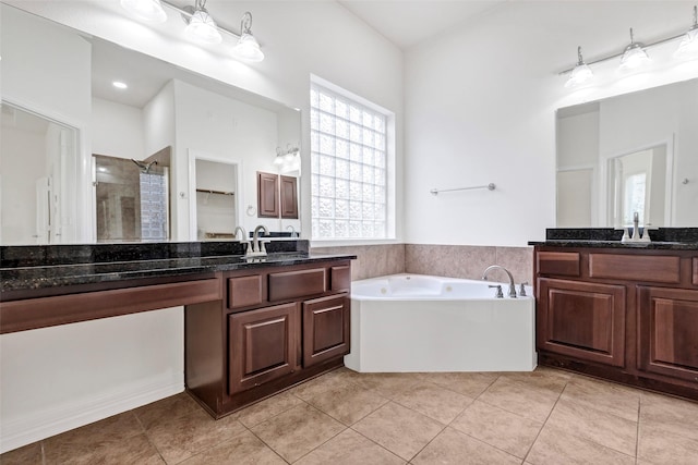 bathroom with independent shower and bath, vanity, and tile patterned floors