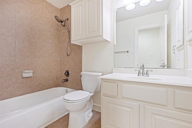 full bathroom featuring tiled shower / bath combo, vanity, tile patterned floors, and toilet