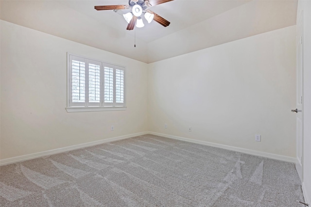 carpeted empty room featuring vaulted ceiling and ceiling fan