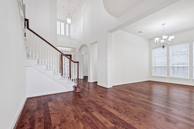 foyer featuring ornamental molding, dark hardwood / wood-style flooring, and a chandelier