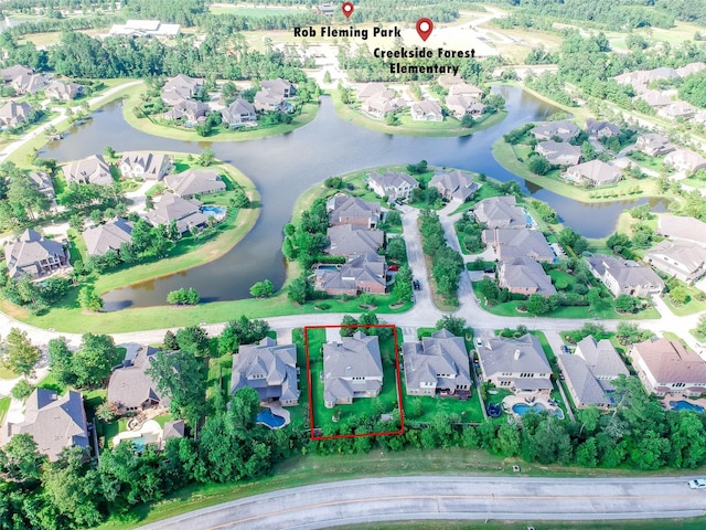 birds eye view of property with a water view