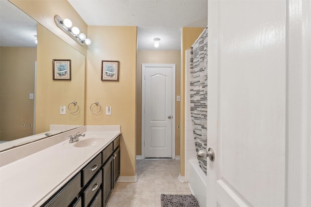 bathroom featuring a textured ceiling, tile patterned floors, and vanity